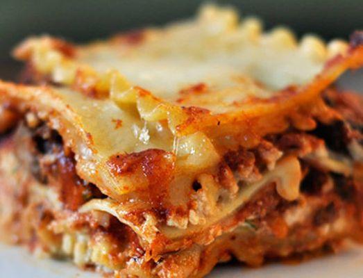 Lasagna is a classic Italian dish made of layers of wide, flat pasta sheets alternating with rich fillings.