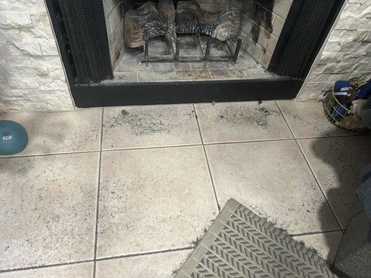 Black soot and ash from fireplace left after the work was "done"