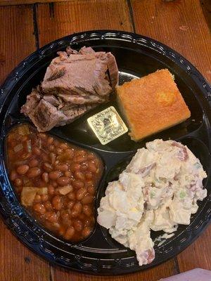 Brisket platter with potato salad baked beans and corn bread