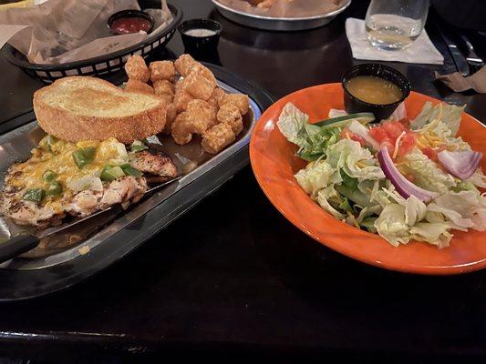 Smothered Chicken Breasts with tater tots and side salad