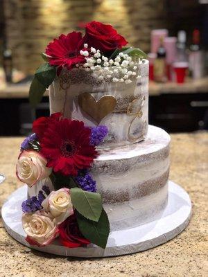 My friends' cake (the florals were placed by us). They made this one too big but they didn't charge her for it.