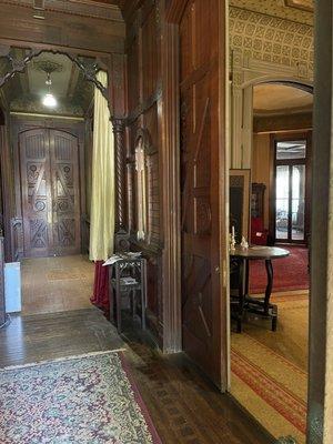 Redwood Pocket doors into the parlor and library. Swinging doors into the back hall.