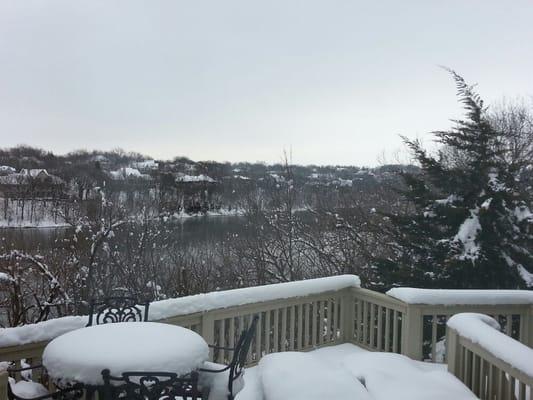 The snow on the trees and lake is beautiful