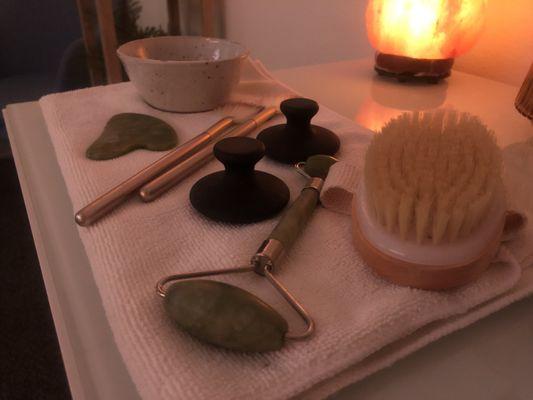 Guasha, Dry Brush Detox, and hot stone massage available to add on during facial services.