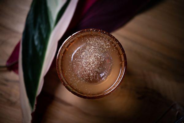 Cocktail with hand-grated nutmeg and ice sphere