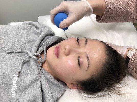 Facial cupping with vitamin E oil to simulate collagen production