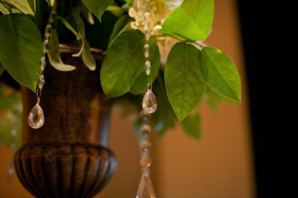 Swarovski Crystal hanging from floral arrangement at the alter.