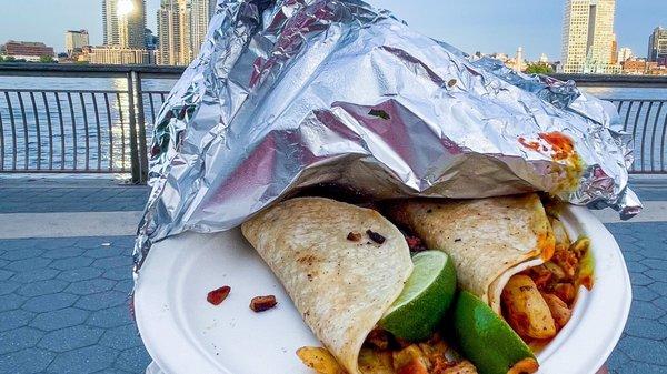 Sitting at the East River Park with Tacos Al Pastor from Los Tacos Poca Madre which is inside Ben's Deli