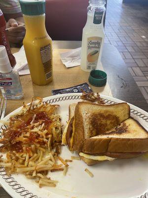 Hash browns with cheese eggs and ham sandwich