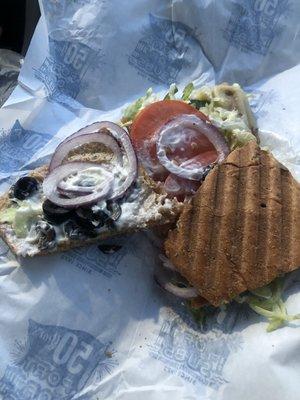 Small vegetarian on wheat bread; toasted with Swiss cheese, Provolone cheese, onions, tomatoes, mayonnaise, lettuce, and black olives