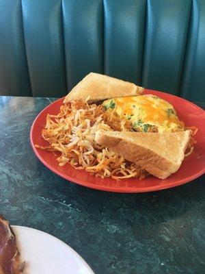 Ham, spinach and cheese omelet, hash browns, and wheat toast.