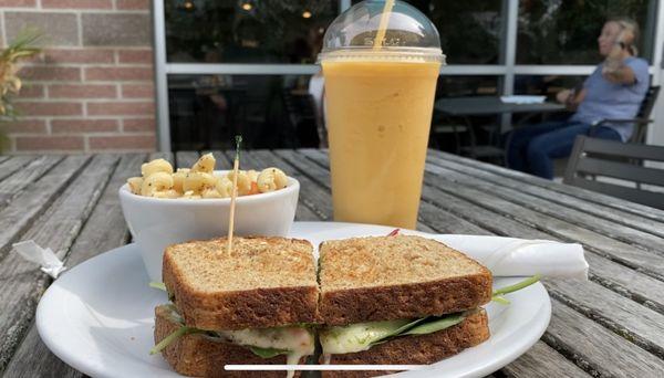 Chicken basil sandwich with a side of pasta salad and a pear, apricot (and some thing) else smoothie.