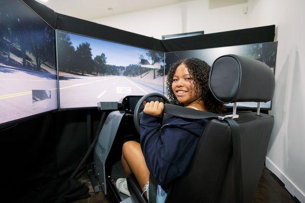 New teen driver buckling into the Greenlight driving simulator.