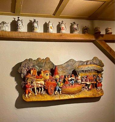 Decor including a wall relief and steins