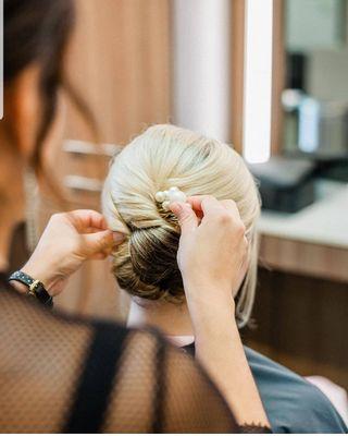 Elegant bridal updo by stylist Brenda. Come to our luxe salon for the best bridal styling in Cornelius, NC.