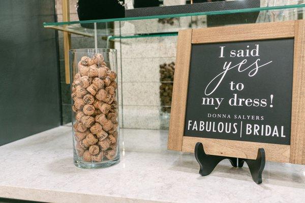 Pop some bubbly with us! Plus sign and date your cork to capture the day you said yes to THE dress!