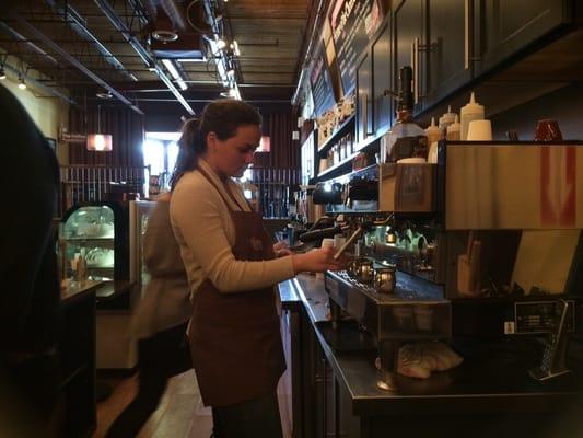 Working the espresso machine.