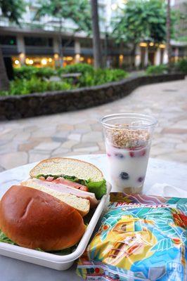 Turkey & Swiss: oven roasted turkey, boar's head swiss cheese, tomato, arugula, dijon mayonnaise, brioche bun ($11). Yogurt Parfait ($7).