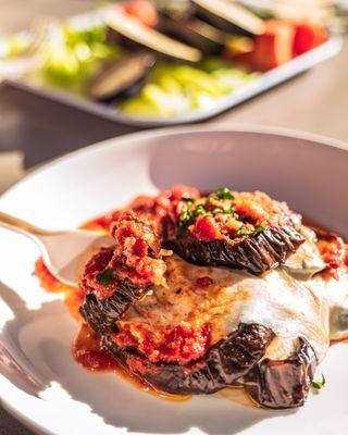 Baked Eggplant Parmigiana (available as regular or vegan option).