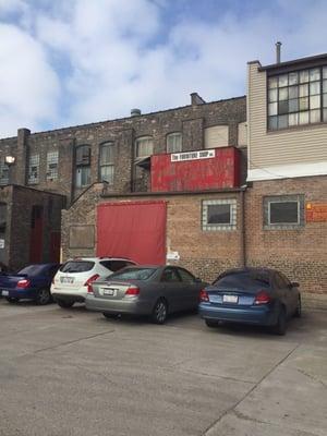 View of entrance from parking lot. Go up the stairs. It's a warehouse and busy workshop.