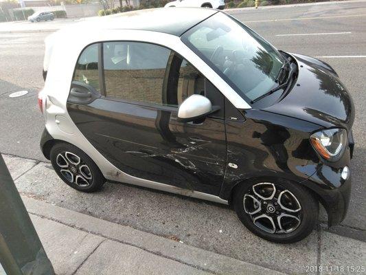 Damage to Smart Car after collision.  Note front wheel.  Damage to other side.  When fixed,  looked brand new.