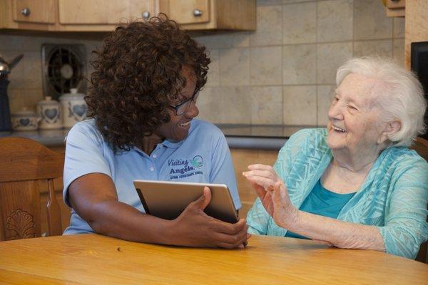 technology, caregiver, senior, women, tablet, home, visiting angels