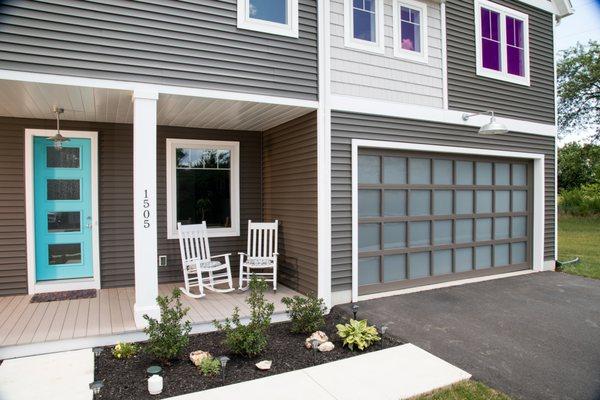 Haas aluminum-full-view sectional overhead garage door installation with frosted glass.