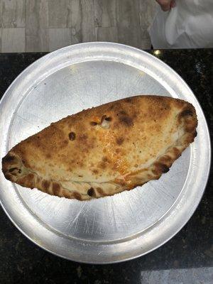 A perfectly cooked and balanced calzone.