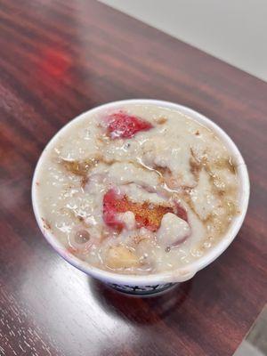 Oatmeal with coconut milk, strawberries and bananas, brown sugar and cinnamon