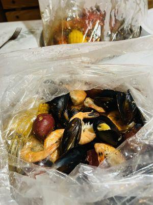 Black mussels and headless shrimp in garlic butter! Break up the potatoes and soak up the yummy juice!