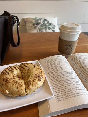 Onion bagel with egg and cheese and a large cinnamon bun latte