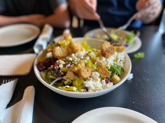 A Greek Salad that's much bigger than this photo let's on