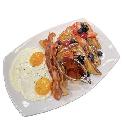 Orange French toast with fresh berries, Bacon and Eggs