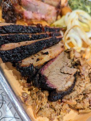 Close-up of Chili-Rubbed Beef Brisket, sliced. Part of our Three Meat Combo. $22.95.