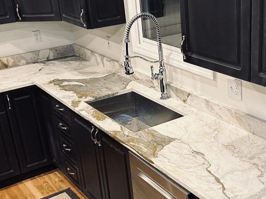 Stunning quartzite countertops with a deep single bowl stainless steel under mount sink & new faucet brought this kitchen back to life !