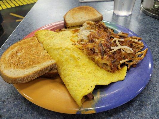 Three Pig Omelet with hashbrowns and sourdough toast