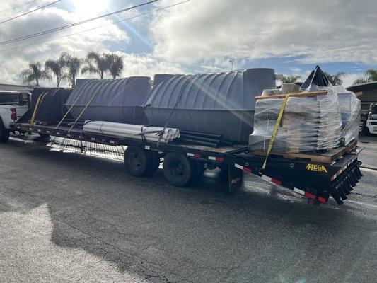 Trailer load of septic system supplies. Chambers, pipe, septic tanks.