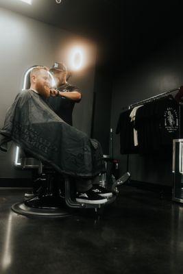 Owner cutting a haircut and beard trim