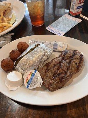 New York Strip baked Potato and hush puppies