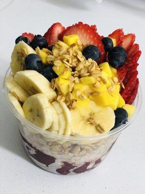 Acai bowl with granola, banana, mango, blueberries, & strawberries.