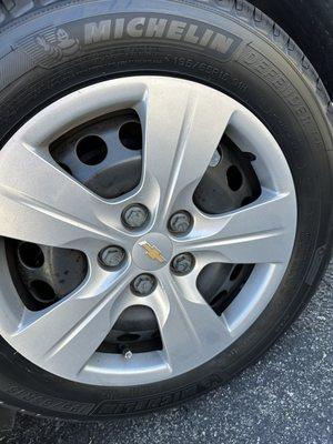 New tire with hubcap installed wrong, socket left marks all over the plastic lugs.