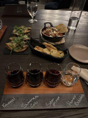 Our wine flight with the food in the background. Far back is the Burrata.