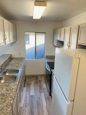 Kitchen After - Repainting, new Sink & Fixtures, Countertop, Flooring, and Refinished Cabinets