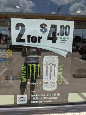 False advertising. Poster shows all varieties of monster drink two for four dollars.