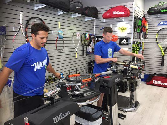 2 guys busily working in restringing tennis rackets in Ft Lauderdale, usually done in less than 30 minutes :)