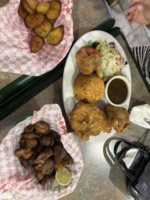 Spanish rice, beans, salad with fried chicken. Sweet plantains and fried pork bites