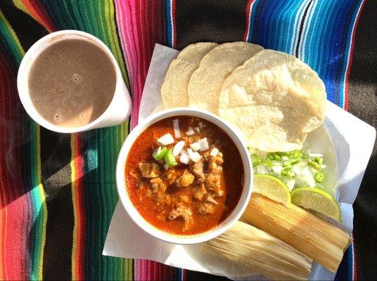 Delicious menudo with handmade tortillas, tamales and champurrado.