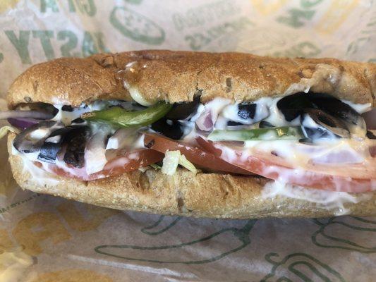 Toasted 6 inch vegetarian on wheat with provolone cheese, Swiss cheese, mayonnaise, lettuce, tomatoes, black olives, bell peppers, and onion