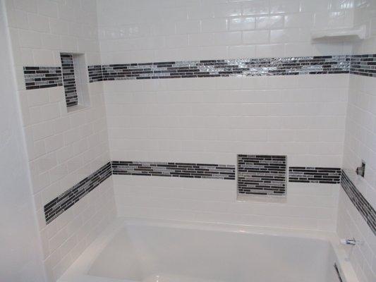 subway tile walls, 2 glass mosaic stripes, 2 recessed shampoo shelves. Tile installation Lakeside, CA