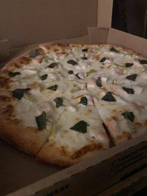 Medium pizza with housemade white sauce, chicken, artichoke, and basil